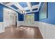 Dining room with striking blue walls, wainscoting, and coffered ceiling at 4924 Theys Rd, Raleigh, NC 27606