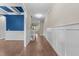 Spacious hallway featuring hardwood floors and elegant wainscoting at 4924 Theys Rd, Raleigh, NC 27606