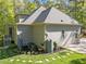 Side exterior of house featuring clean siding, trimmed bushes, and well-maintained lawn at 4924 Theys Rd, Raleigh, NC 27606