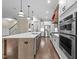 Gourmet kitchen featuring a large island, stainless appliances, double ovens, and a decorative hood at 4924 Theys Rd, Raleigh, NC 27606