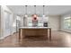 Spacious kitchen with a large central island, stainless steel appliances, and custom hood vent at 4924 Theys Rd, Raleigh, NC 27606