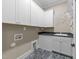 Bright laundry room featuring white cabinets, a utility sink, and connections for a washer and dryer at 4924 Theys Rd, Raleigh, NC 27606
