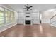 Bright living room with fireplace, built-in shelving, and large windows at 4924 Theys Rd, Raleigh, NC 27606