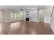 Open living room with hardwood floors, built-in shelves, fireplace, and large window at 4924 Theys Rd, Raleigh, NC 27606