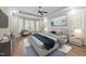Tastefully staged main bedroom with hardwood floors and a cozy seating area at 4924 Theys Rd, Raleigh, NC 27606