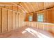 A look inside the unfinished outbuilding, featuring framed construction, windows, and workbench at 4924 Theys Rd, Raleigh, NC 27606