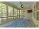 Cozy screened porch features large windows and a ceiling fan at 4924 Theys Rd, Raleigh, NC 27606