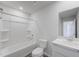 Clean bathroom featuring a shower-tub combo, modern toilet, vanity, and modern sink with neutral paint at 51 Landon Pl, Roxboro, NC 27573