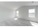 A bright bedroom features carpet, an angled ceiling, multiple windows, and neutral paint at 51 Landon Pl, Roxboro, NC 27573