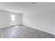Bright bedroom with neutral walls, gray wood flooring, and ample natural light at 51 Landon Pl, Roxboro, NC 27573