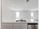 Bright, open kitchen with a stainless steel double-sink, dishwasher, and marble countertops at 51 Landon Pl, Roxboro, NC 27573