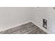 Neat laundry room area with hookups, neutral walls, and gray wood flooring at 51 Landon Pl, Roxboro, NC 27573
