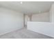 Upstairs loft area with carpet, neutral walls, and access to other rooms at 51 Landon Pl, Roxboro, NC 27573