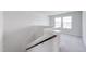 Upstairs staircase area featuring neutral walls, carpeted floor, and natural light at 51 Landon Pl, Roxboro, NC 27573