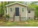 Charming house with tan siding and black door and lots of surrounding trees at 6121 Kelvin Dr, Durham, NC 27712