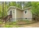 View of the home exterior showing neutral siding and front entrance at 6121 Kelvin Dr, Durham, NC 27712
