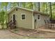 View of the house exterior, patio, and surrounded by mature trees at 6121 Kelvin Dr, Durham, NC 27712