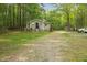 Property view with house, shed, long driveway and ample space at 6121 Kelvin Dr, Durham, NC 27712