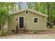 Charming exterior with neutral siding, black front door, and steps at 6121 Kelvin Dr, Durham, NC 27712