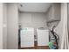 Well-equipped laundry area featuring a washer, dryer, and storage shelves for maximum convenience at 6121 Kelvin Dr, Durham, NC 27712