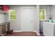 Functional laundry area with a washer, dryer, utility sink, and ample storage space at 6121 Kelvin Dr, Durham, NC 27712