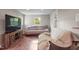 Cozy living room, hardwood floors, and a large window providing natural light at 6121 Kelvin Dr, Durham, NC 27712
