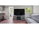 Cozy living room with rustic TV stand, flatscreen, and comfortable couch at 6121 Kelvin Dr, Durham, NC 27712