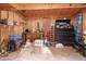 Garage/Storage area equipped with work tables, tools, ladder, and secure storage at 6121 Kelvin Dr, Durham, NC 27712