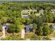 An aerial view of a home with a long drive and mature tree landscaping in a lush, green neighborhood at 6907 Field Hill Rd, Raleigh, NC 27603