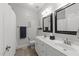 Well-lit bathroom with double vanity, framed mirrors, and modern fixtures at 6907 Field Hill Rd, Raleigh, NC 27603