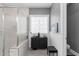 Bathroom featuring a decorative window, glass enclosed shower, and calming zen decor at 6907 Field Hill Rd, Raleigh, NC 27603