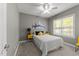 A cozy bedroom features neutral walls, plush carpet, window, ceiling fan, and colorful accents at 6907 Field Hill Rd, Raleigh, NC 27603