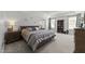 Large bedroom features a bed, bookcase, and natural light from windows at 6907 Field Hill Rd, Raleigh, NC 27603