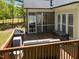 Back deck showing outdoor seating, a grill, and views of the backyard and surrounding trees at 6907 Field Hill Rd, Raleigh, NC 27603