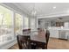 Dining room featuring hardwood floors, lots of natural light, and access to another area of the house at 6907 Field Hill Rd, Raleigh, NC 27603