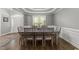Well-lit dining room with hardwood floors, elegant tray ceiling and decorative furnishings at 6907 Field Hill Rd, Raleigh, NC 27603