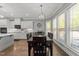 Bright dining room with hardwood floors, white cabinets and an elegant chandelier lighting the dining table at 6907 Field Hill Rd, Raleigh, NC 27603
