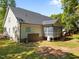 Back exterior view of home and the backyard with a deck and a screened in porch at 6907 Field Hill Rd, Raleigh, NC 27603