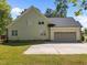 Rear view of house, showing garage and door to backyard at 6907 Field Hill Rd, Raleigh, NC 27603