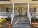Charming front porch with decorative glass front door and sconces at 6907 Field Hill Rd, Raleigh, NC 27603