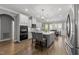 Light filled kitchen boasts an island and stainless steel appliances at 6907 Field Hill Rd, Raleigh, NC 27603