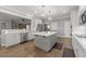 A modern kitchen with stainless steel appliances, an island, and hardwood floors at 6907 Field Hill Rd, Raleigh, NC 27603
