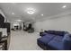Large living room with a comfortable blue sectional sofa, recessed lighting, and plenty of space for activities at 6907 Field Hill Rd, Raleigh, NC 27603