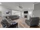 Spacious living room with a plush sectional, fireplace and open layout to the dining room at 6907 Field Hill Rd, Raleigh, NC 27603