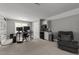 Versatile living room features built-in shelving, a kitchenette with modern appliances, and a comfortable armchair at 6907 Field Hill Rd, Raleigh, NC 27603