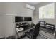 Bright home office featuring a modern desk setup with dual monitors and natural light from the window at 6907 Field Hill Rd, Raleigh, NC 27603