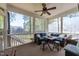 Screened-in porch features comfortable seating and a ceiling fan for relaxing outdoors at 6907 Field Hill Rd, Raleigh, NC 27603