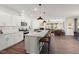 Bright open-concept kitchen featuring a large granite island with bar seating, stainless appliances and an open view to the living room at 716 Ben Ledi Ct, Raleigh, NC 27603