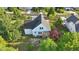 Aerial view showcases a home with a gray roof and white siding, enhanced by a spacious backyard at 72 Cokesbury Park Ln, Fuquay Varina, NC 27526