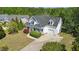 Aerial view of a white two-story home with a gray roof, front porch, garage, and well-maintained landscaping at 72 Cokesbury Park Ln, Fuquay Varina, NC 27526